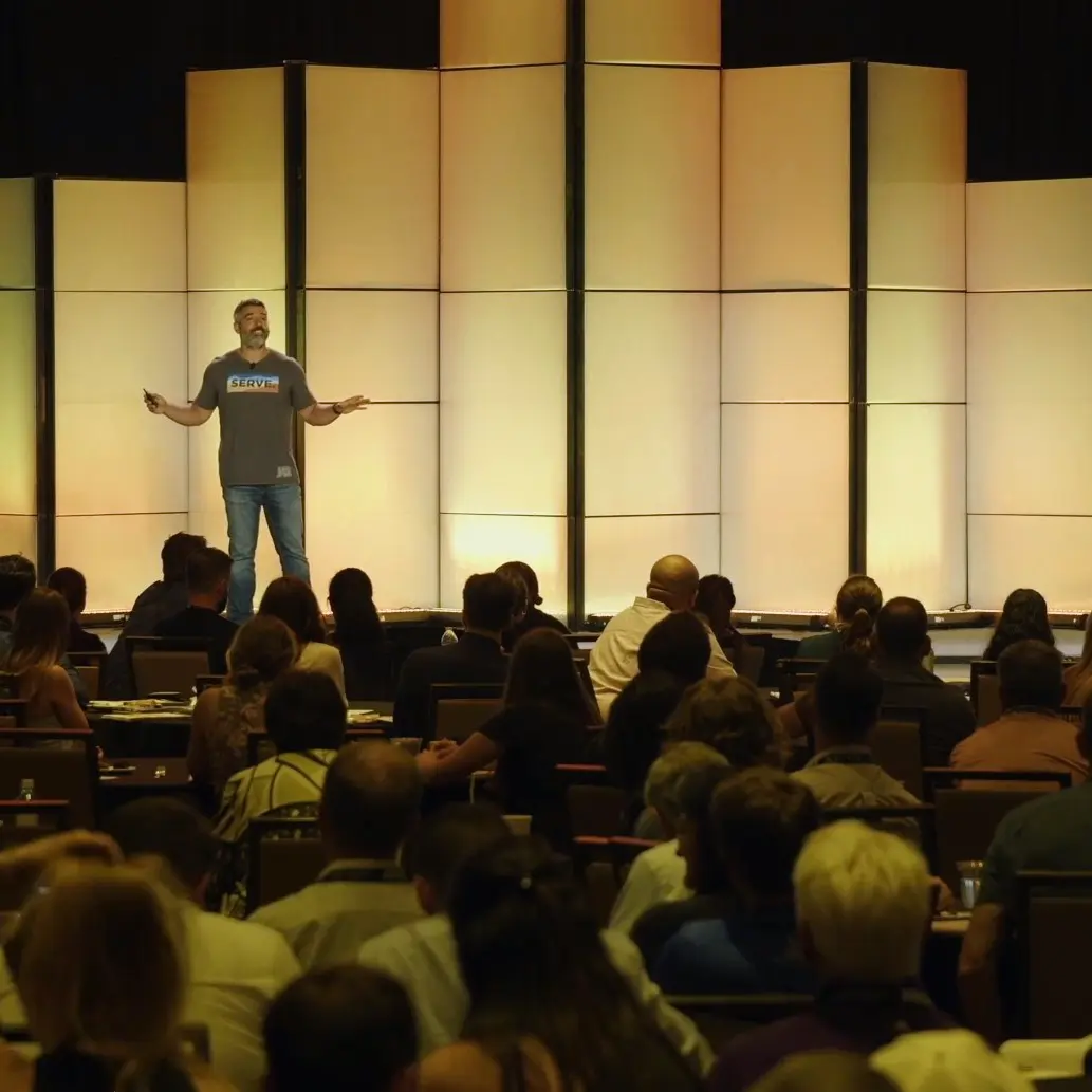 Image of Dr. Jason Tanoory speaking in front of a crowd