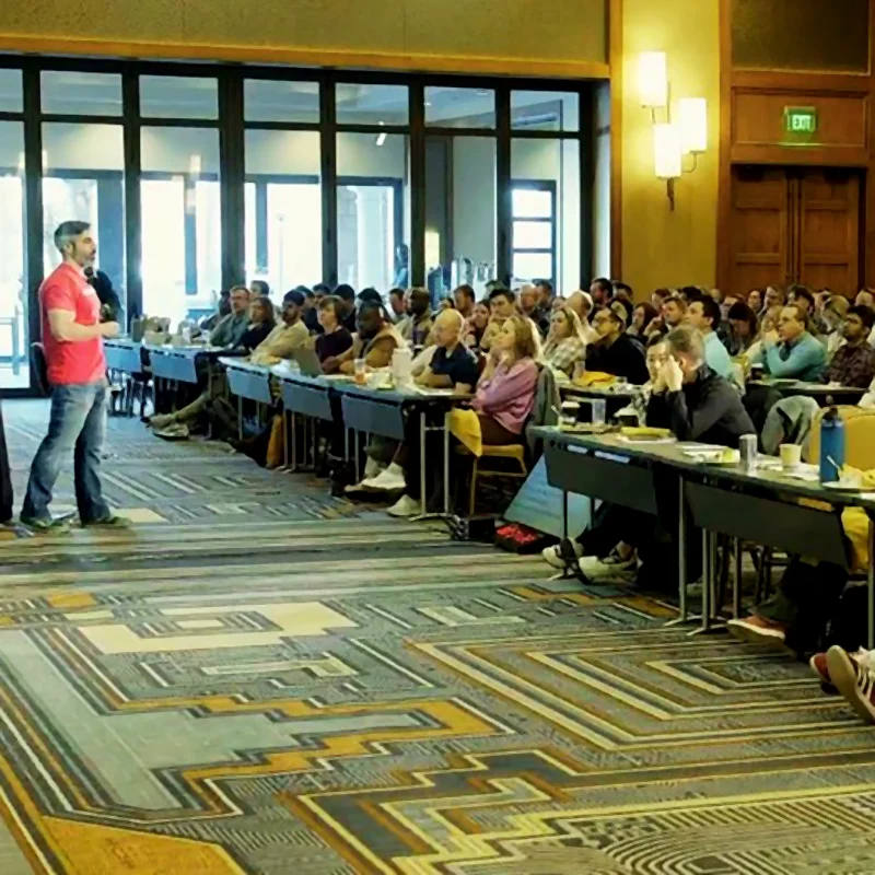 Image of Dr. Jason Tanoory speaking in front of a crowd