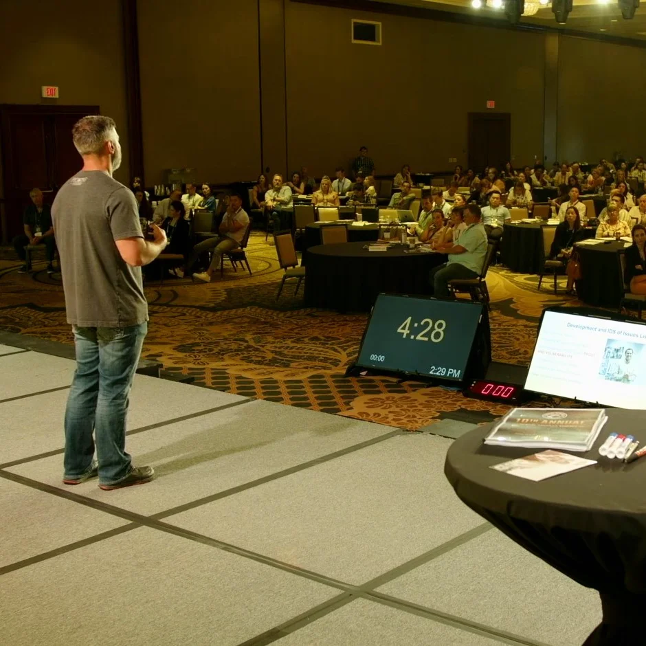 Image of Dr. Jason Tanoory speaking in front of a crowd