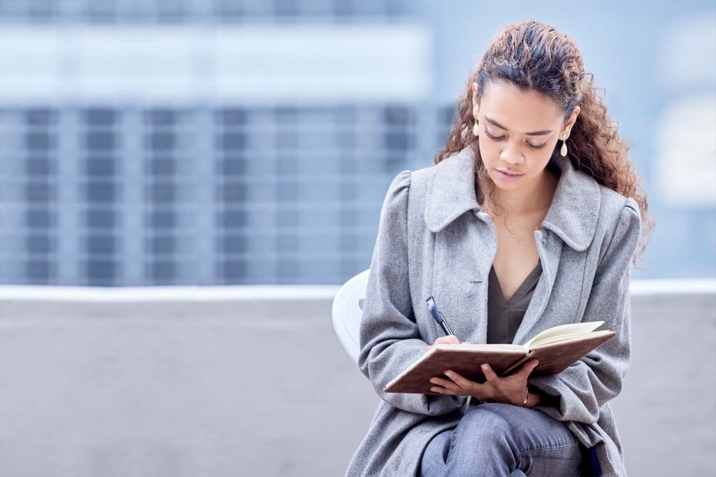 woman writing in notebook