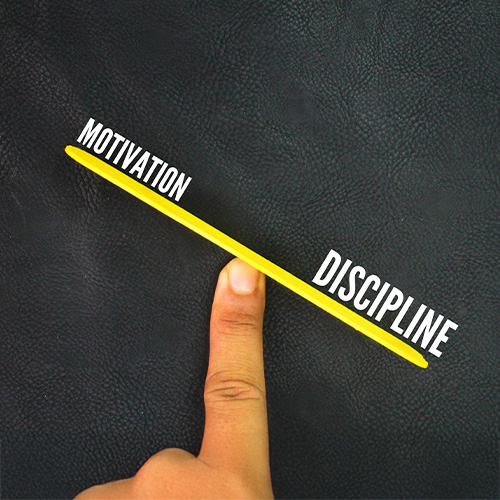 hand measuring motivation and discipline.